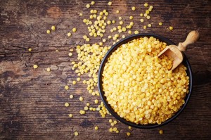 Bowl of yellow indian lentils on wooden background